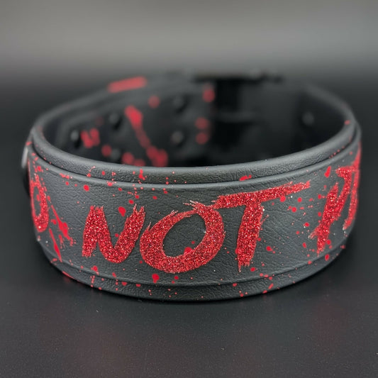 2 inch wide black layered biothane dog collar with black hardware and red glitter do not pet text and splatter paint