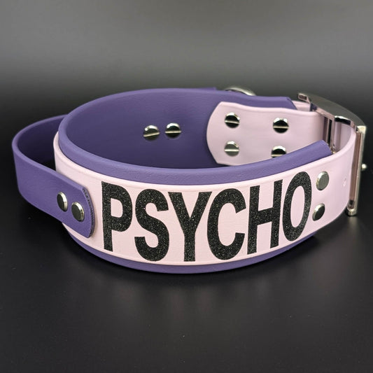 2 inch wide dark purple and lavender layered biothane tactical handle dog collar with psycho glitter text