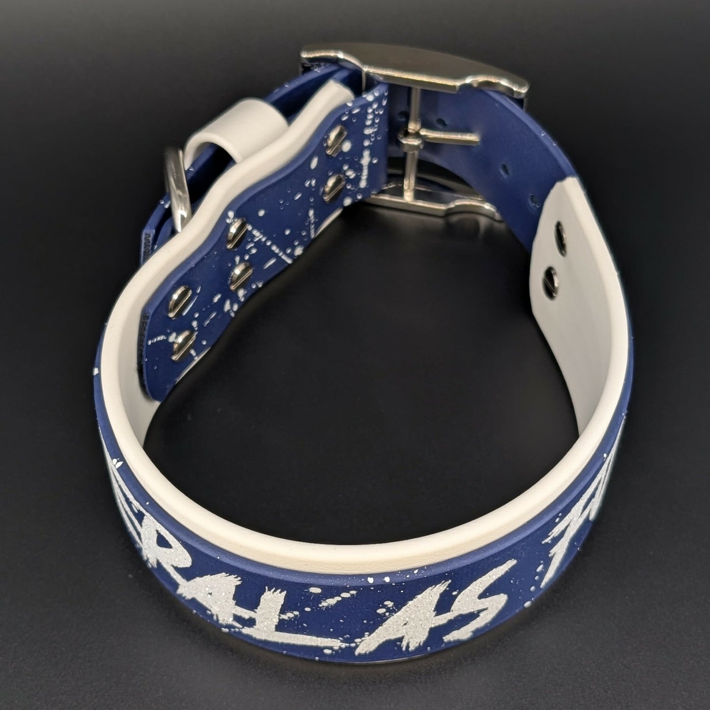 2 inch wide white and navy blue biothane dog collar with splatter paint and glitter feral as fuck text