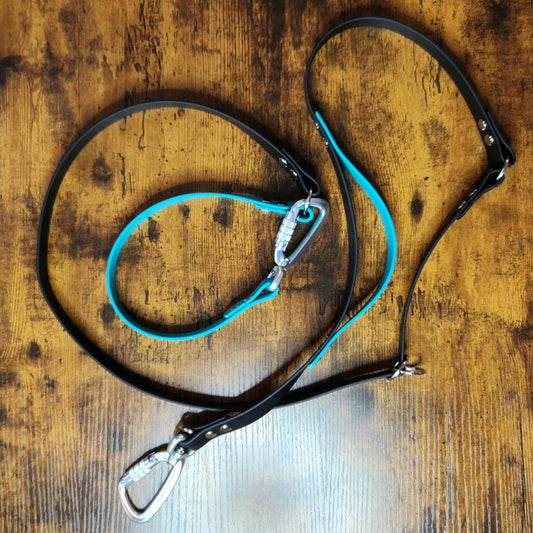 black and teal biothane hands free dog leash with built in traffic handle and adjustable waist attachment point and twist lock carabiners