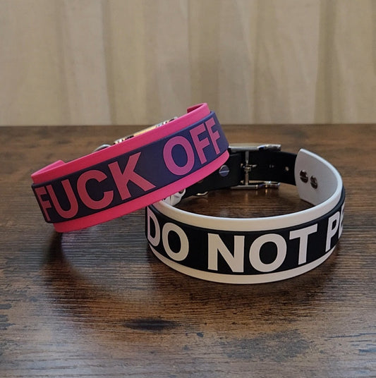 two layered biothane dog collar with custom text, one pink and black reading "FUCK OFF" and the other white and black reading "DO NOT PET"