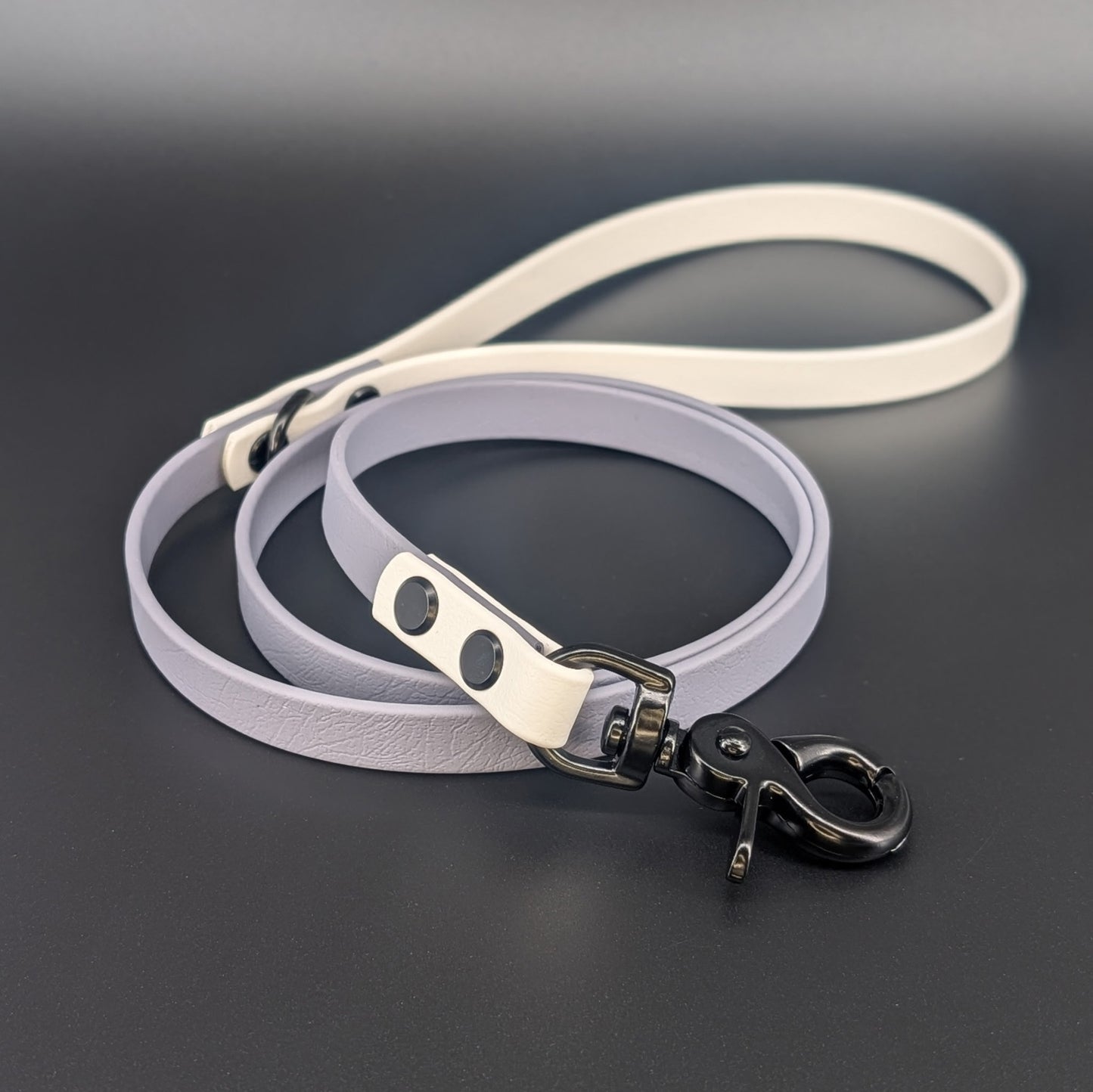 gray and white biothane dog leash with black hardware