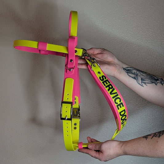 pink and yellow biothane service dog harness with counterbalance handle and pull strap for mobility assistance dog