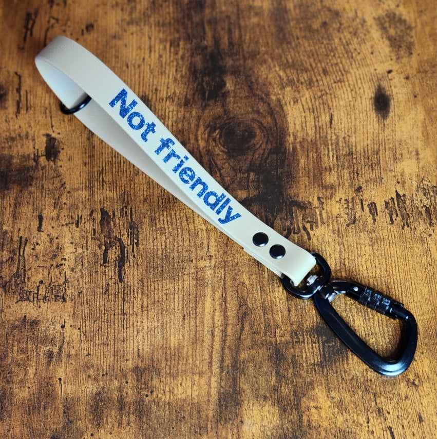 tan biothane traffic handle with custom text and carabiner clip