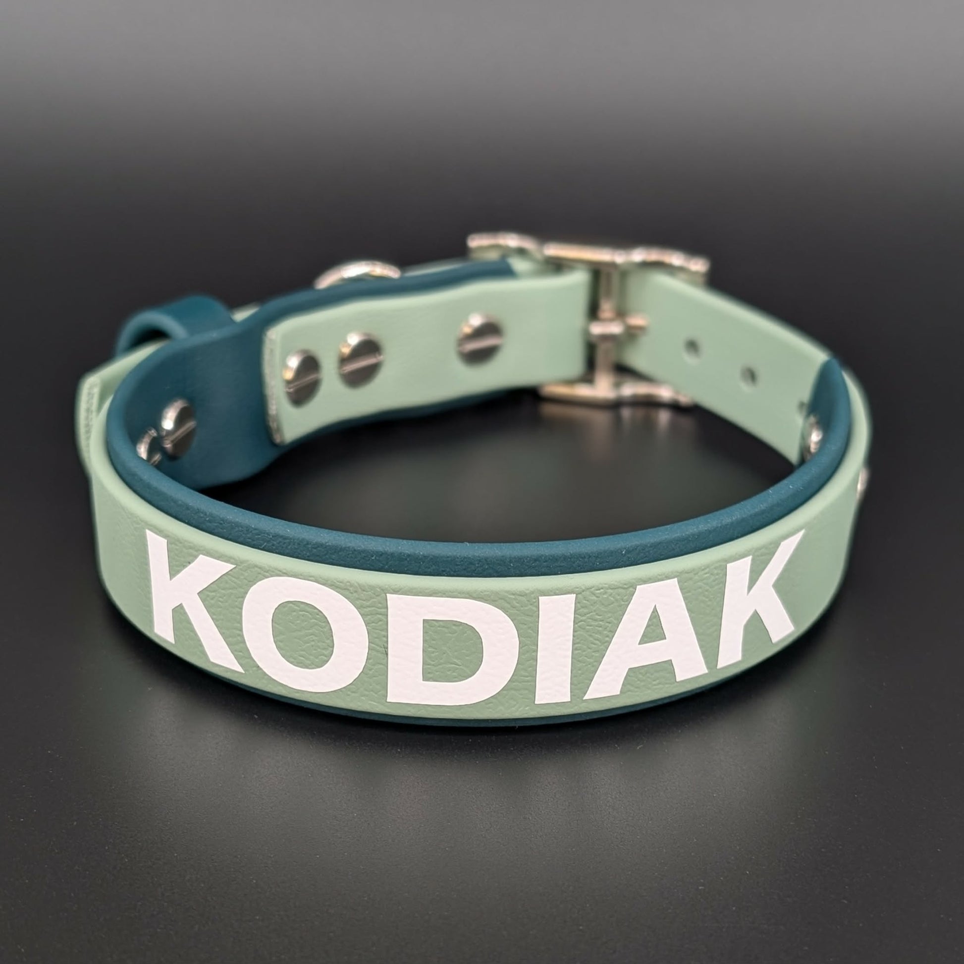 1 inch wide dark and sage green layered biothane dog collar with custom text