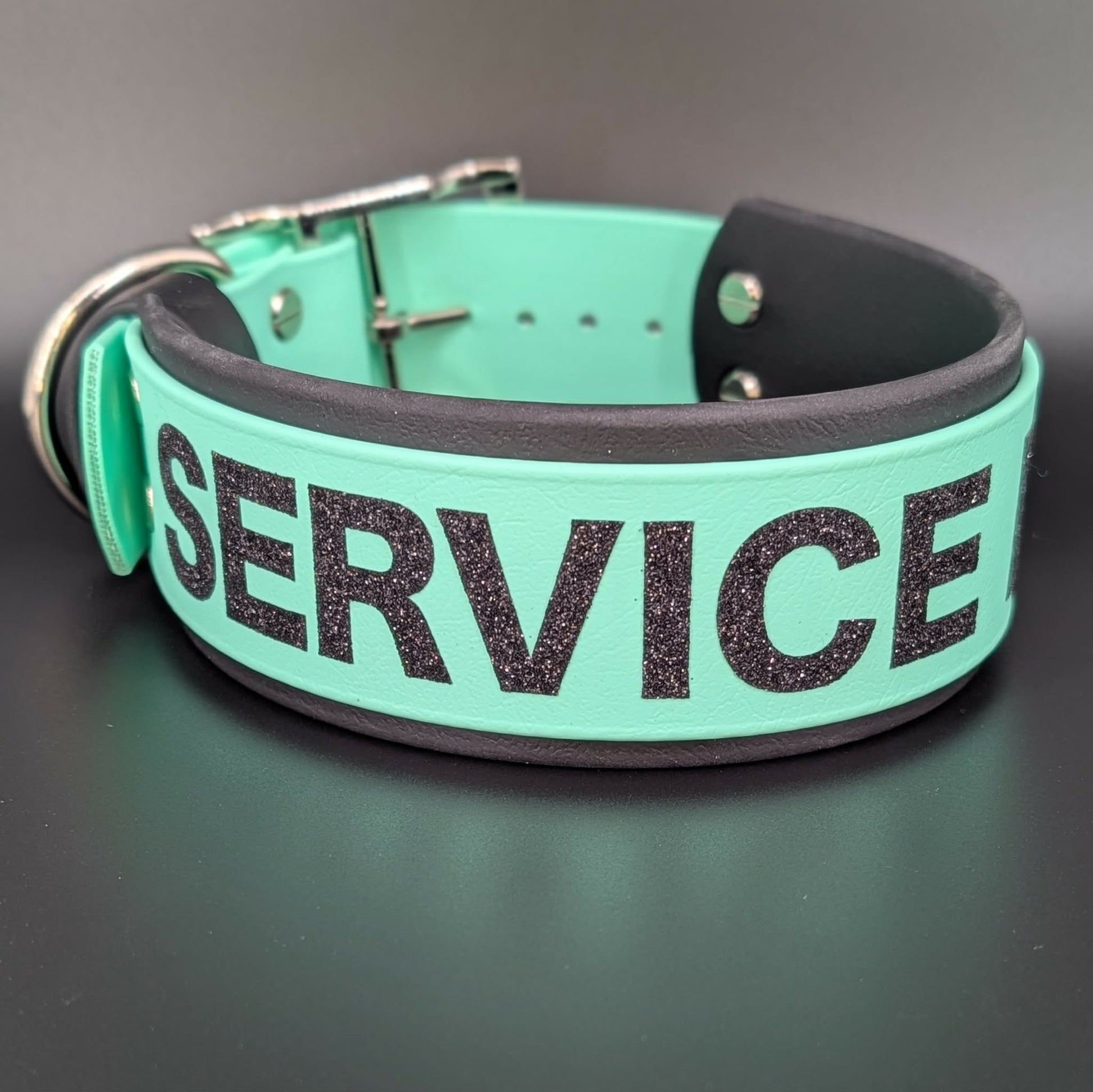 2 inch wide black and mint green layered biothane dog collar with service dog text