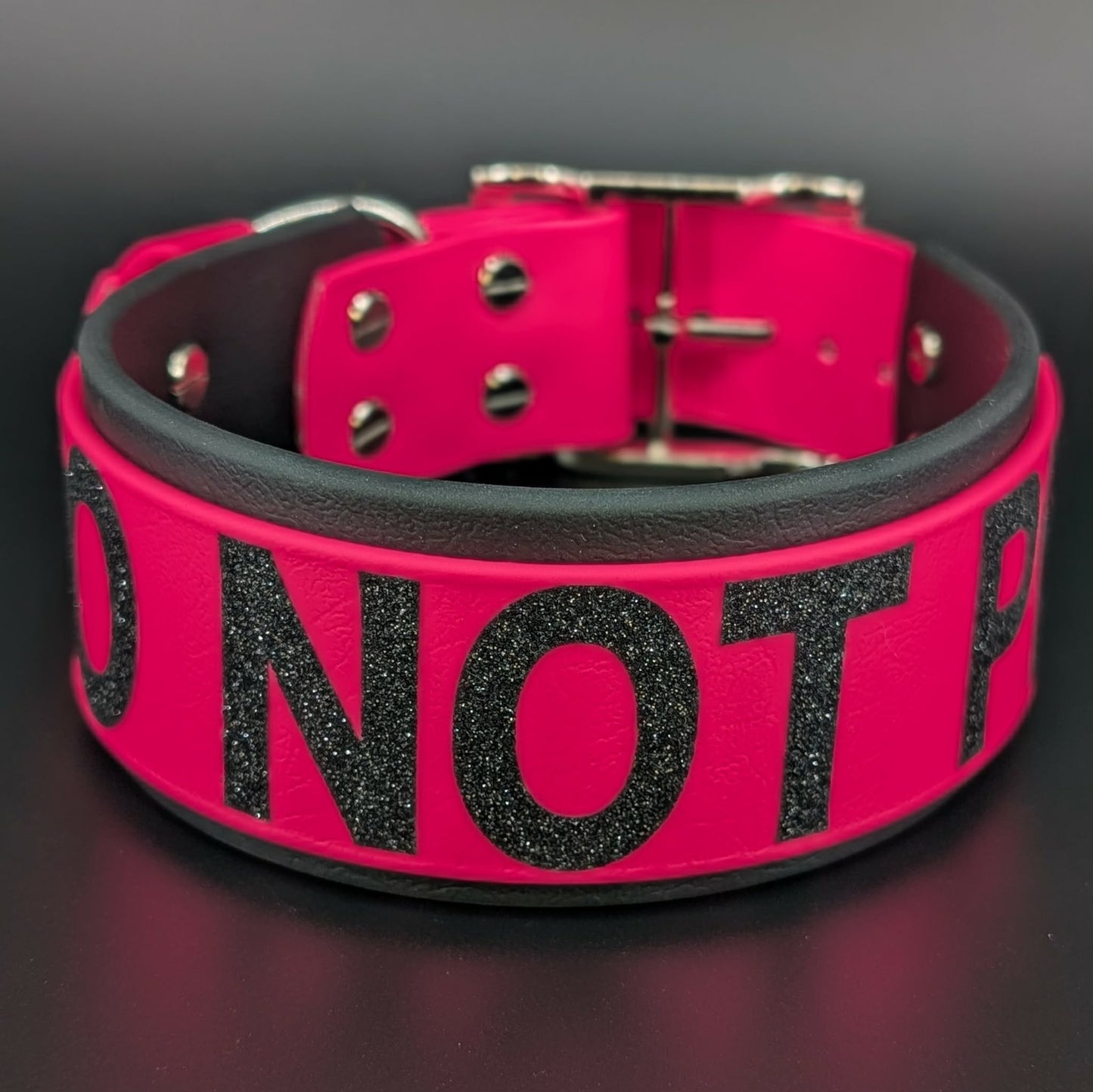 2 inch wide black and pink layered biothane collar with glitter do not pet text