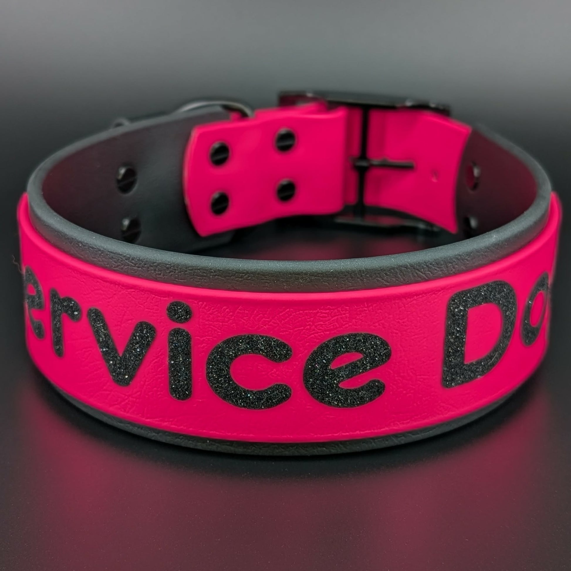 2 inch wide black and pink layered biothane collar with service dog glitter text