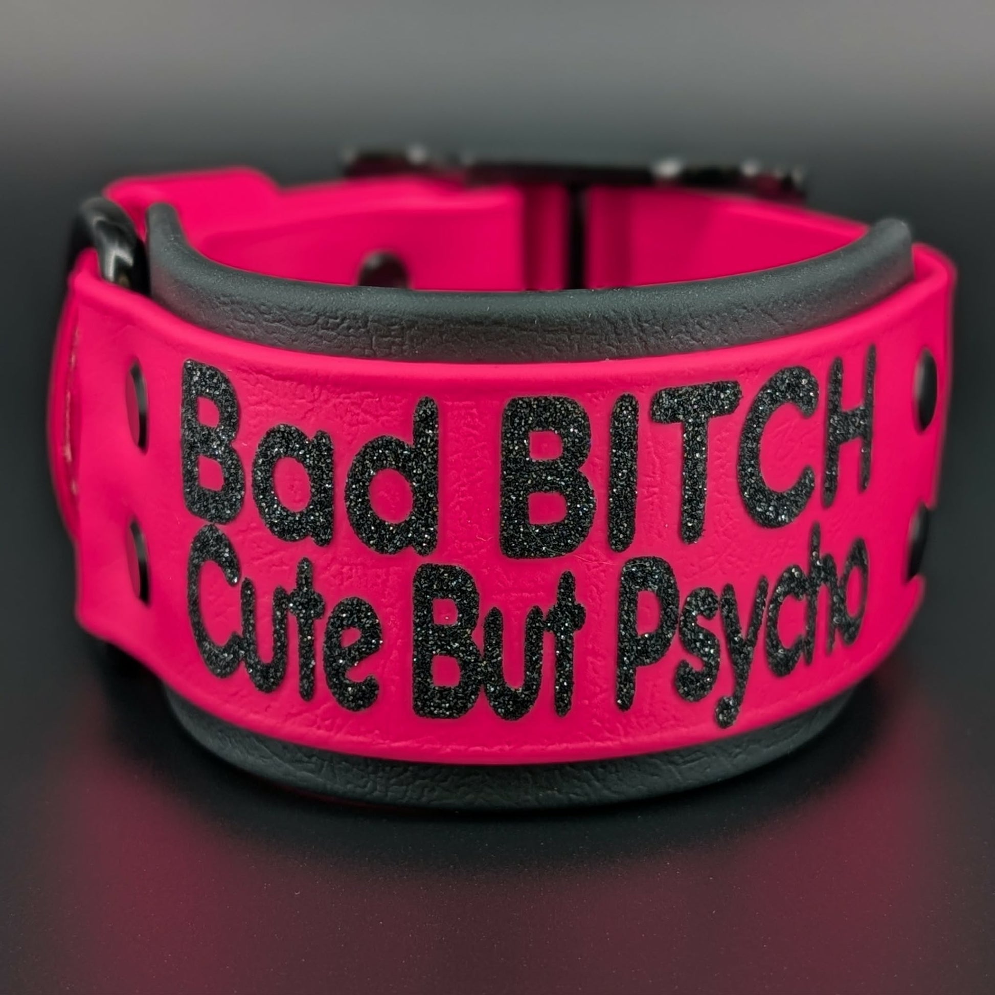 2 inch wide black and pink layered biothane dog collar with glitter text reading bad bitch cute but psycho