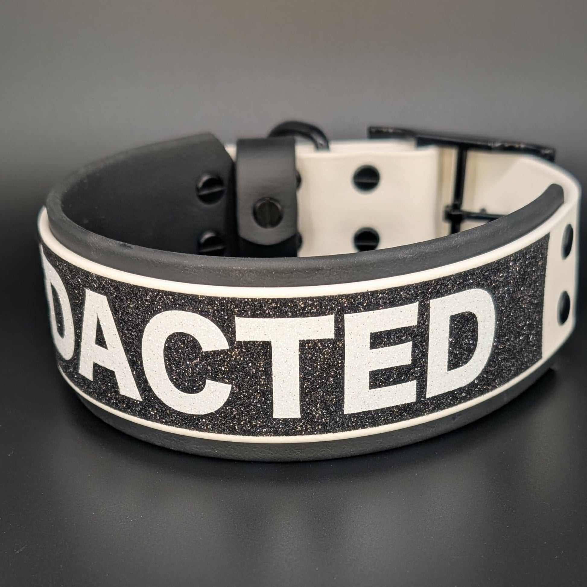 2 inch wide black and white layered biothane dog collar with redacted text