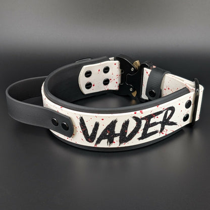 2 inch wide black and white layered biothane dog collar with tactical handle splatter paint and cobra buckle