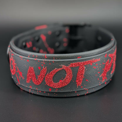 2 inch wide black layered biothane dog collar with black hardware and red glitter do not pet text and splatter paint