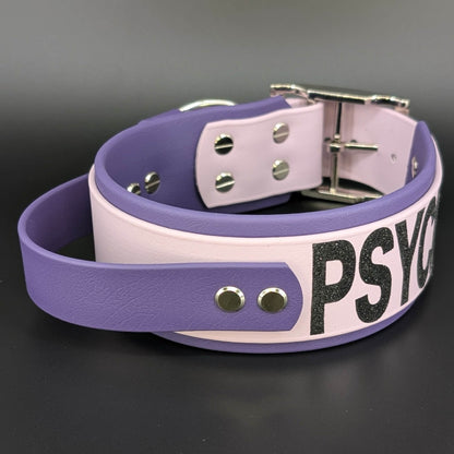 2 inch wide dark purple and lavender biothane tactical handle dog collar with psycho glitter text