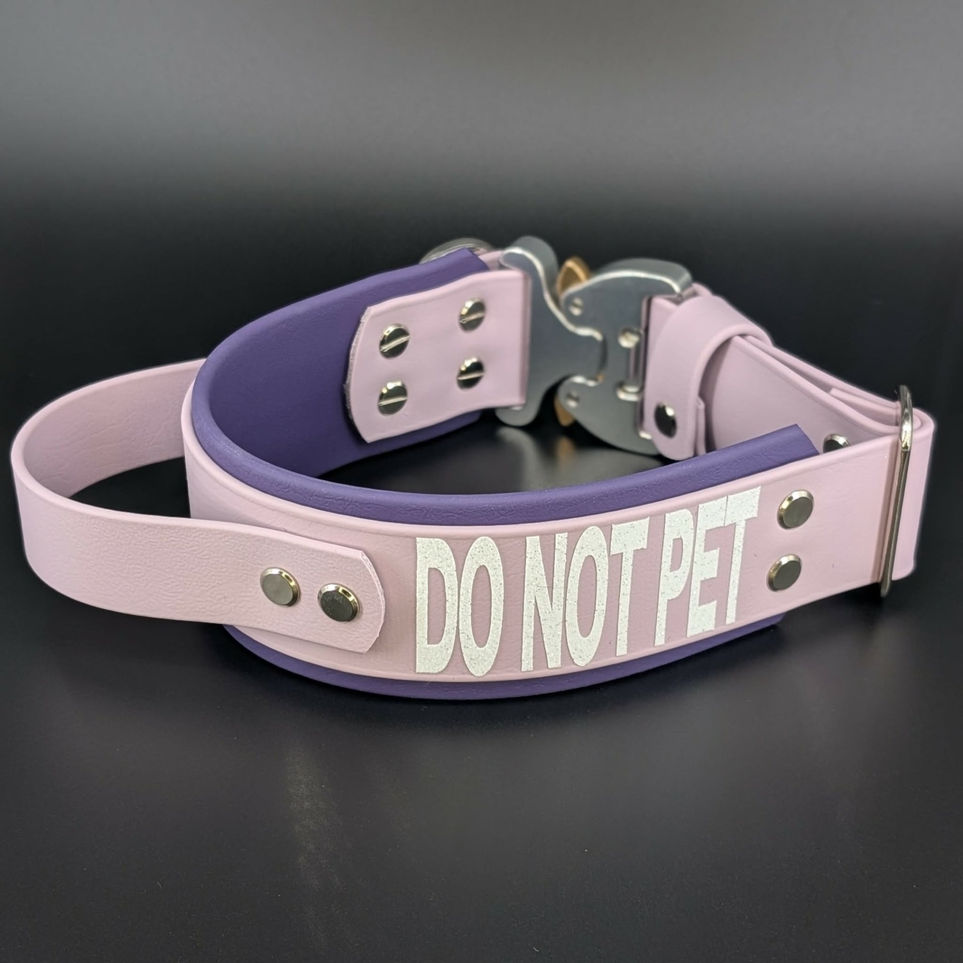2 inch wide dark purple and lavender layered biothane dog collar with tactical handle quick release cobra buckle and do not pet text