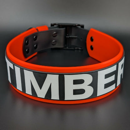 2 inch wide orange and black layered biothane dog collar with personalized text reading timber