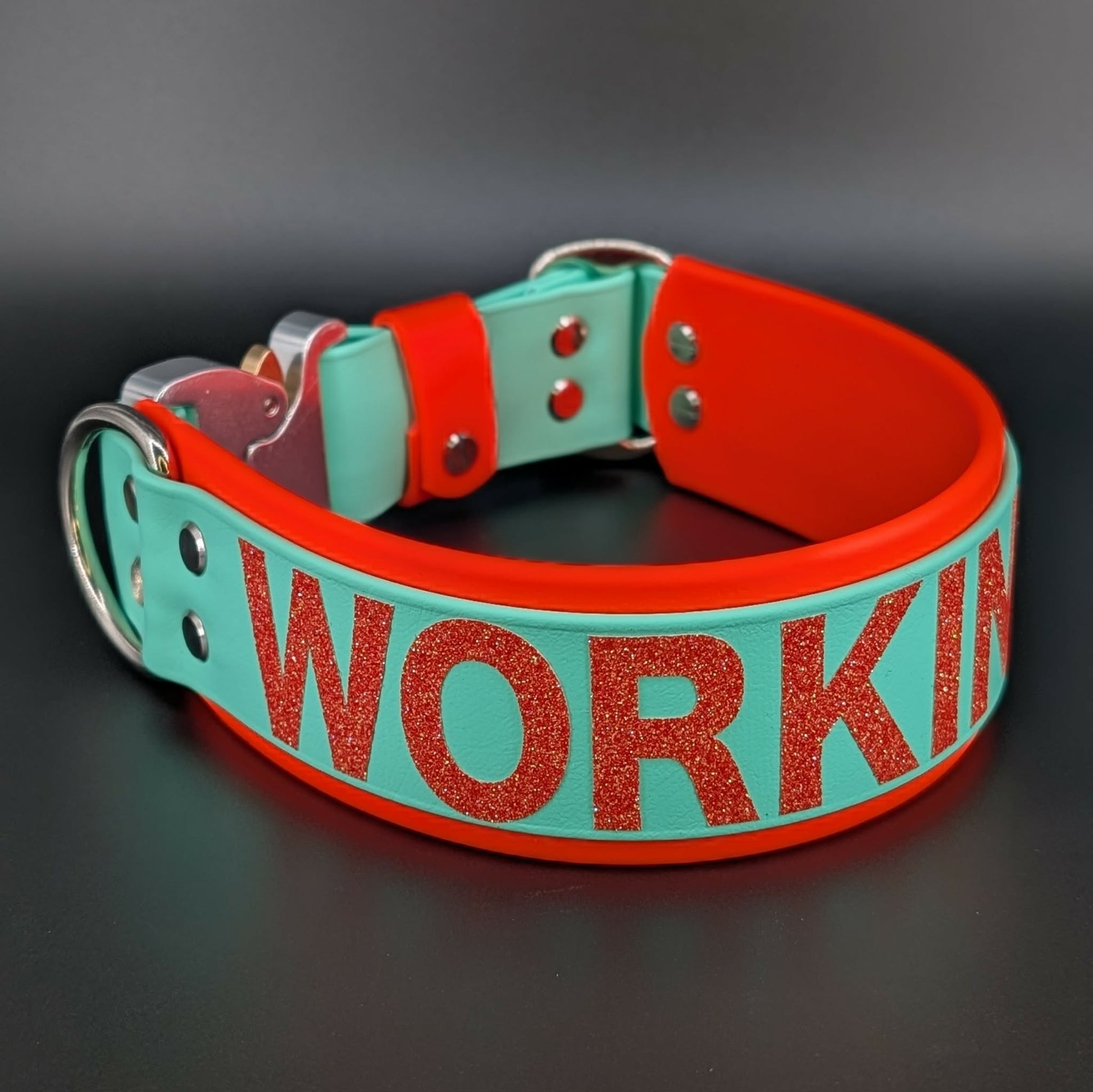2 inch wide orange and mint green layered biothane dog collar with heavy duty quick release cobra buckle and orange glitter working k9 text