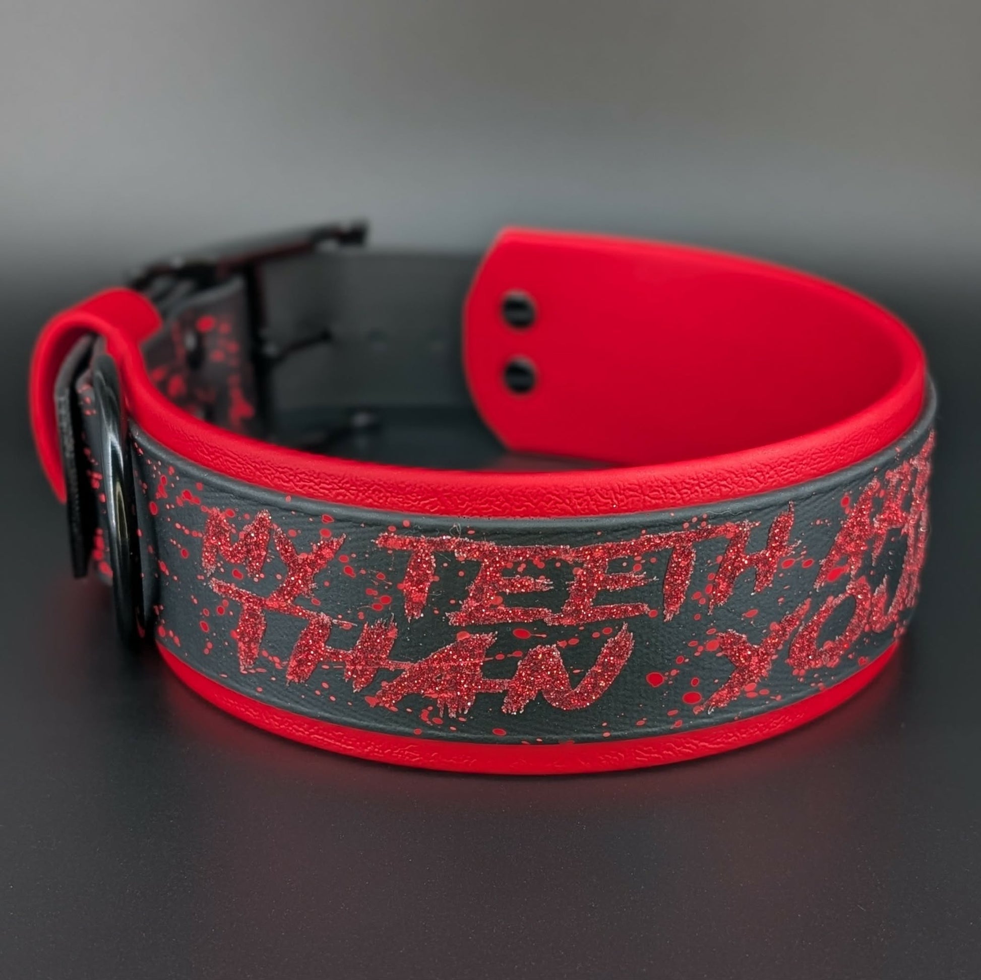 2 inch wide red and black layered biothane dog collar with red splatter paint black hardware and glitter my teeth are bigger than your dick text