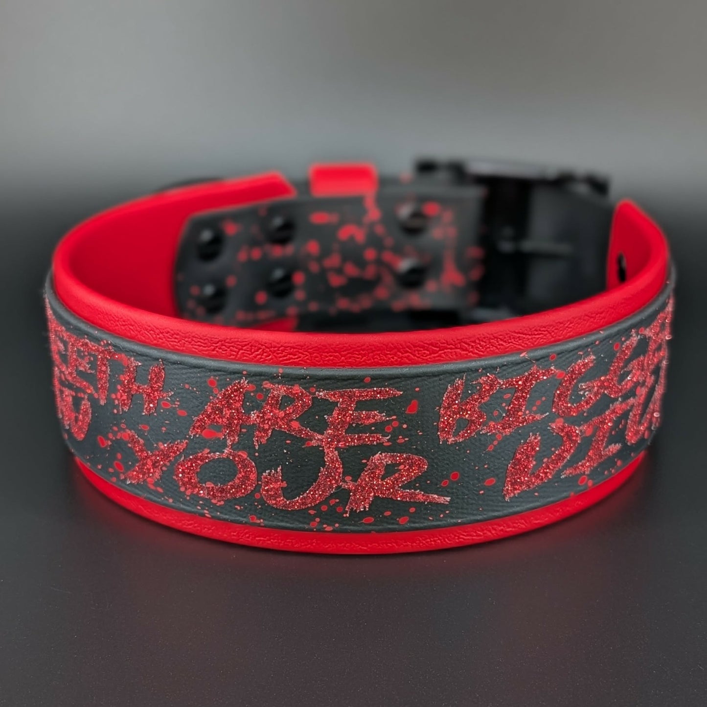 2 inch wide red and black layered biothane dog collar with red splatter paint black hardware and red glitter my teeth are bigger than your dick text