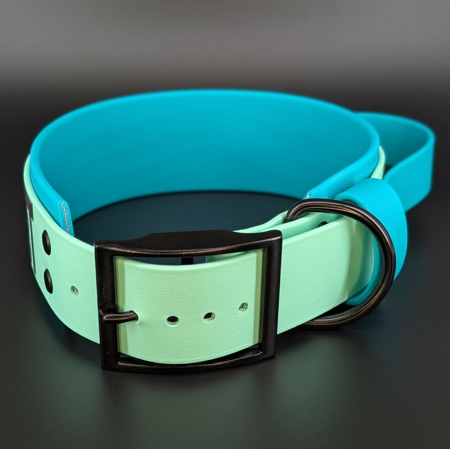 2 inch wide teal and mint green layered biothane dog collar with tactical handle and black hardware