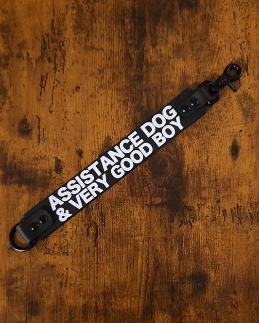 black biothane leash wrap with white text reading "ASSISTANCE DOG & VERY GOOD BOY"