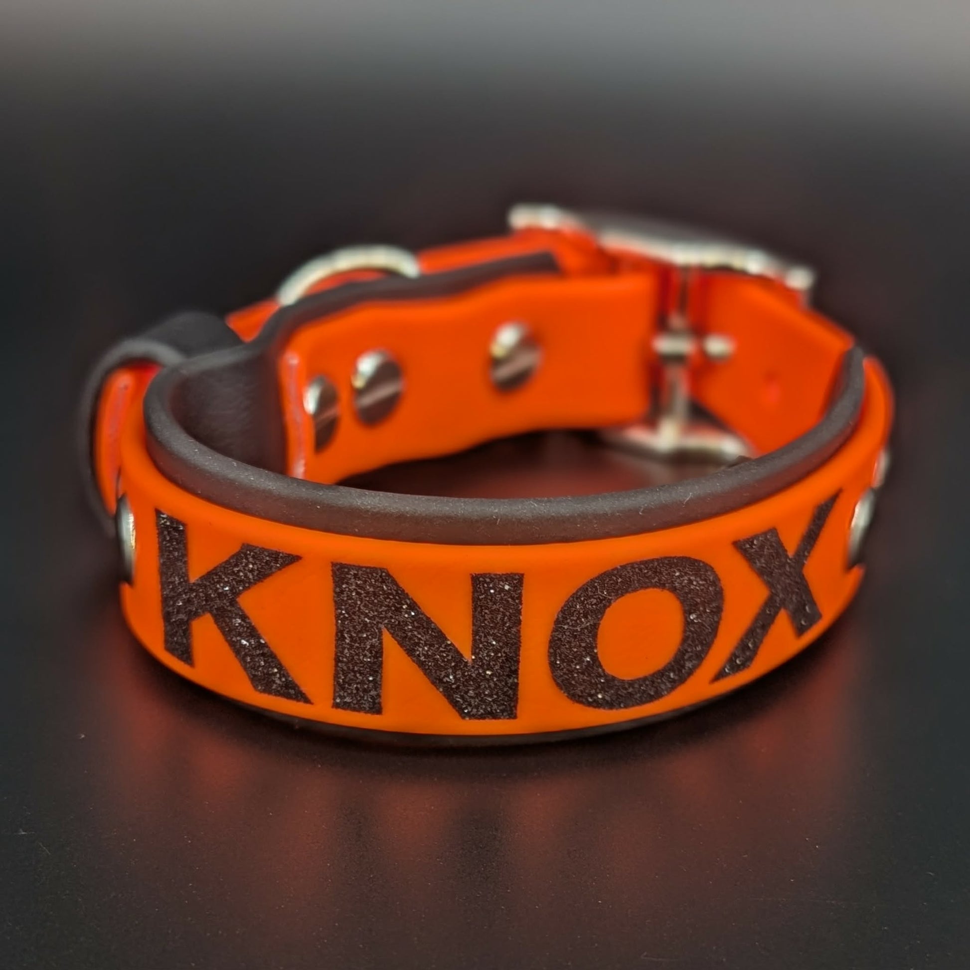 black and orange layered biothane dog collar with custom glitter text