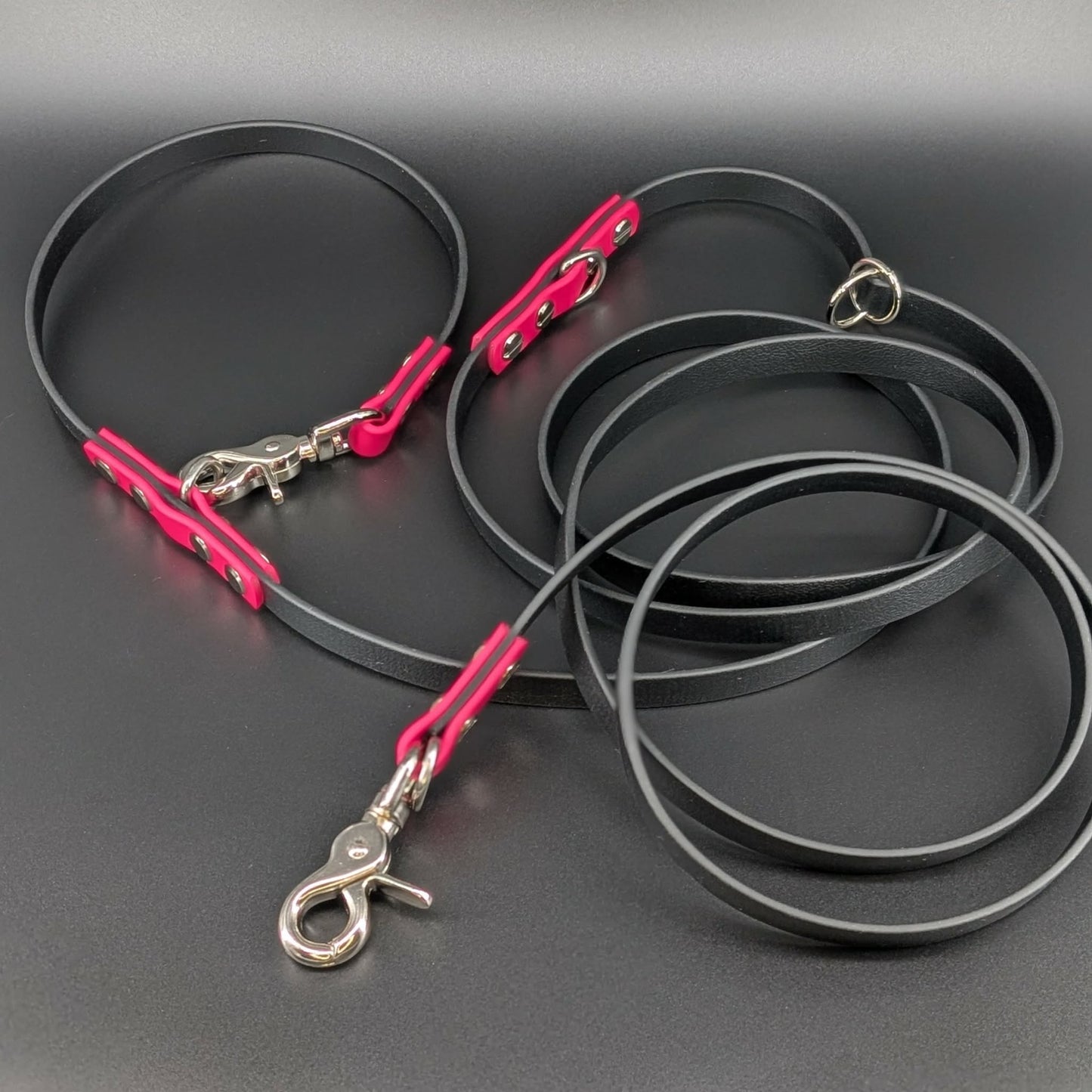 black and pink biothane hands free dog leash with adjustable waist attachment