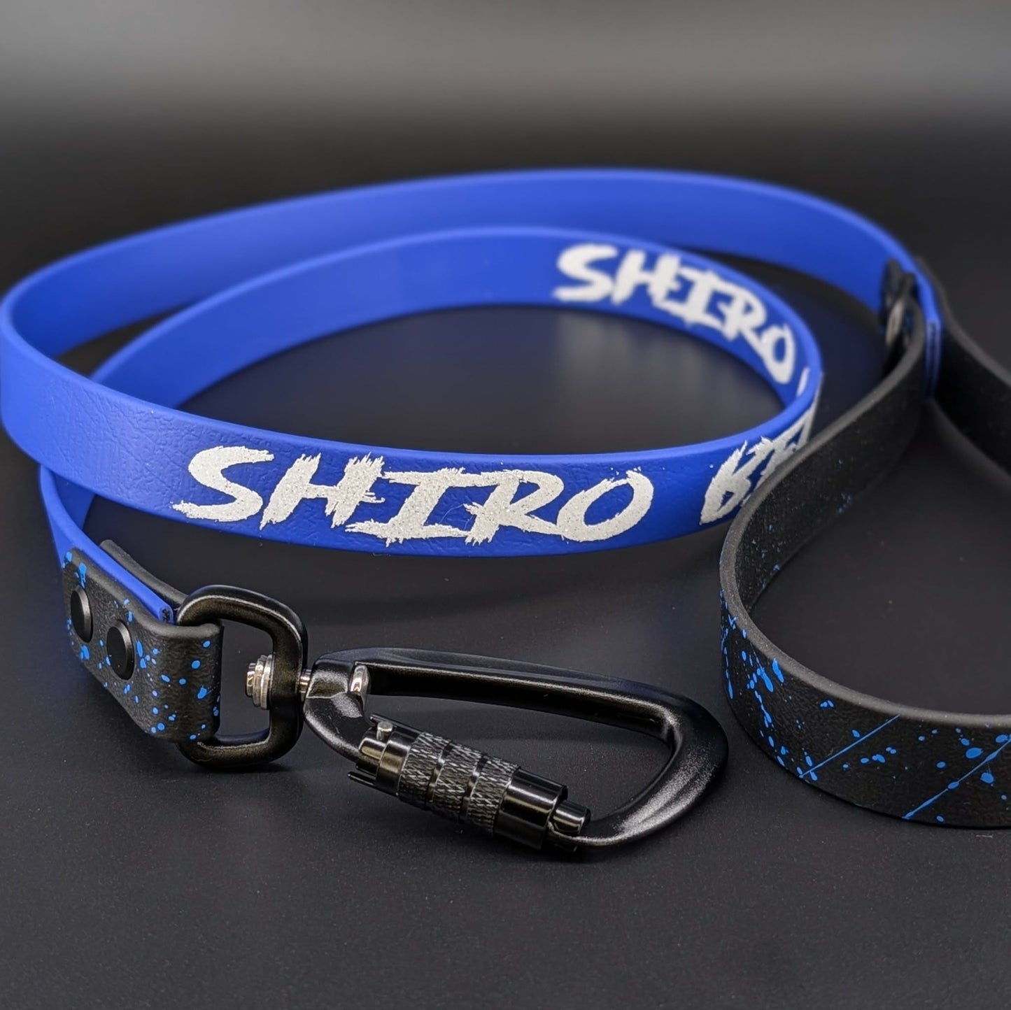 black and royal blue biothane dog leash with royal blue splatter paint and custom text