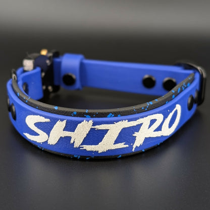 black and royal blue layered biothane dog collar with splatter paint custom text and quick release cobra buckle