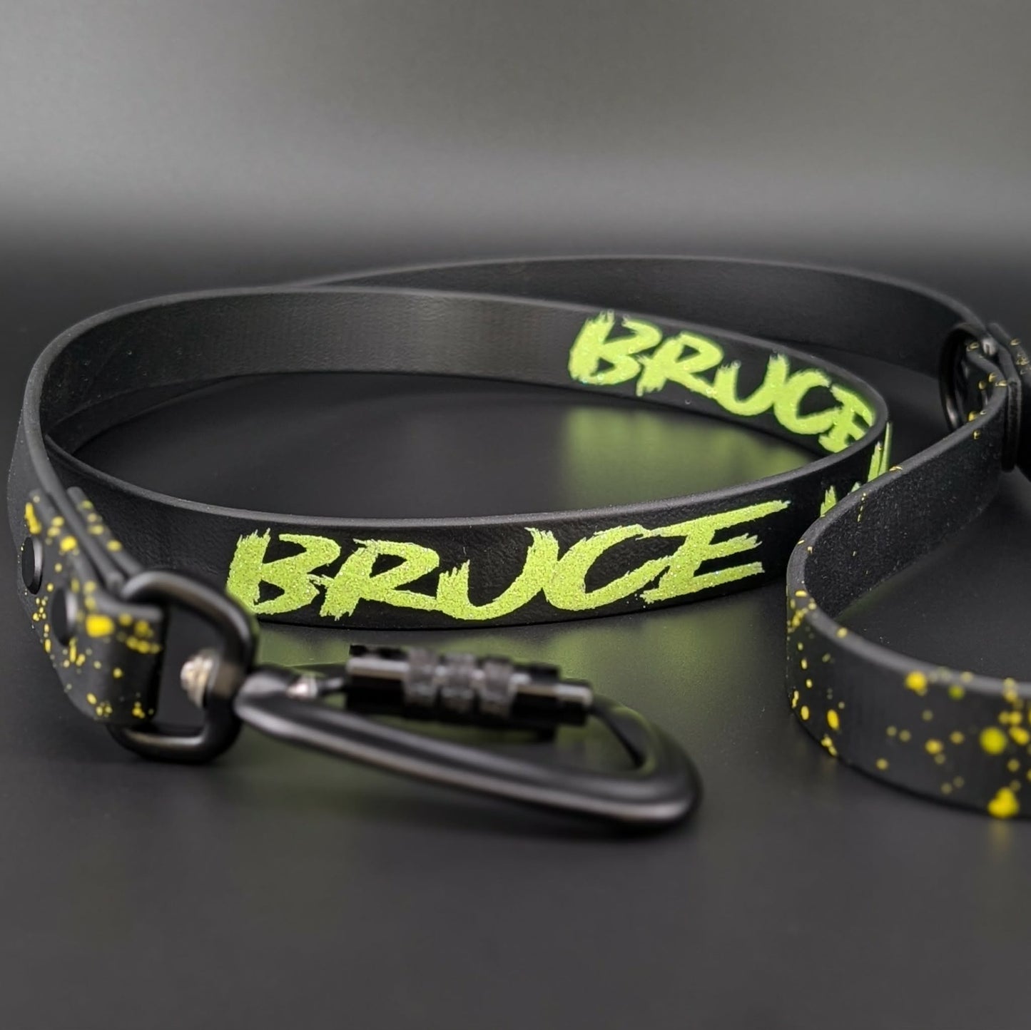 black biothane dog leash with yellow splatter paint and custom text