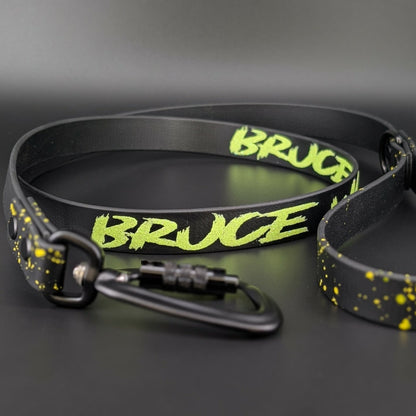 black biothane dog leash with yellow splatter paint and custom text