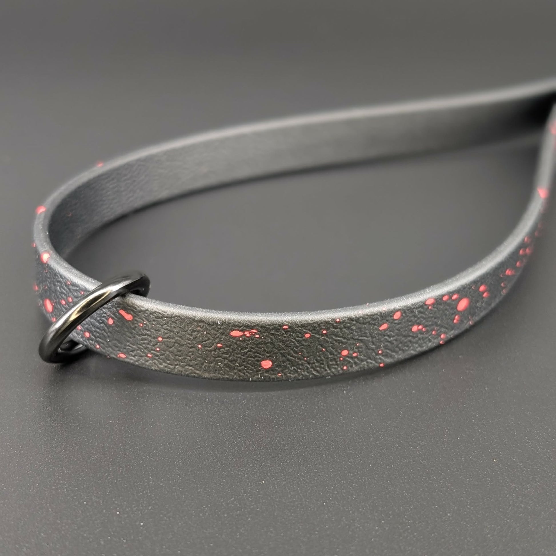 black biothane traffic handle with red splatter paint
