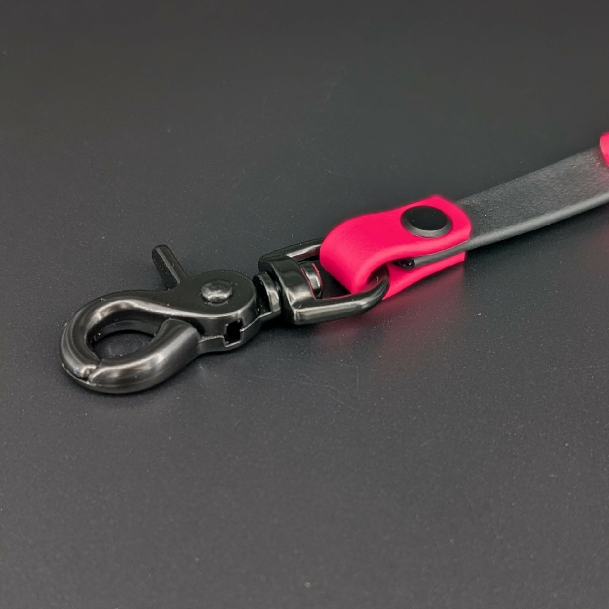 black hardware on black and pink biothane prong collar backup clip