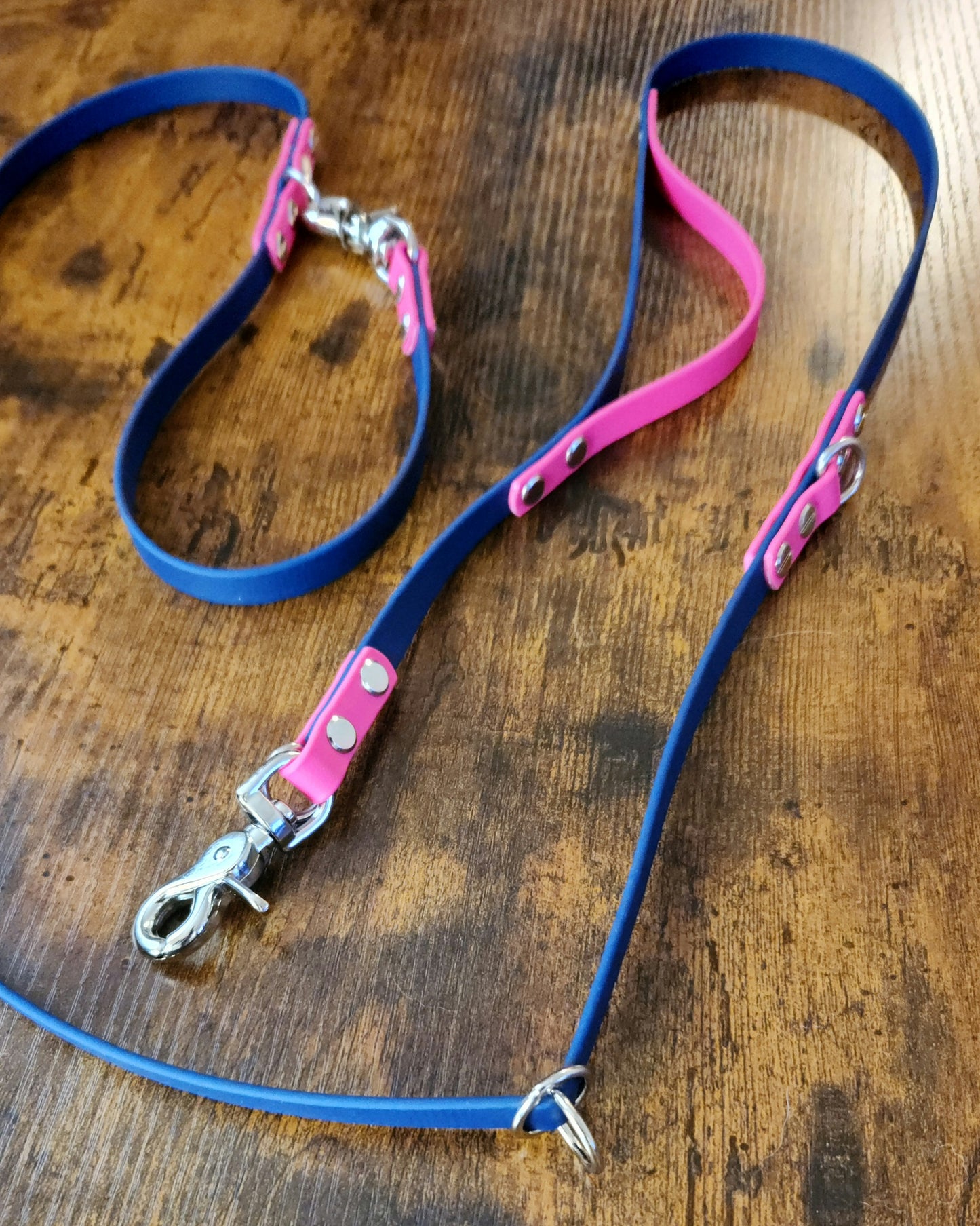 blue and pink biothane hands free dog leash with built in traffic handle and adjustable waist attachment point