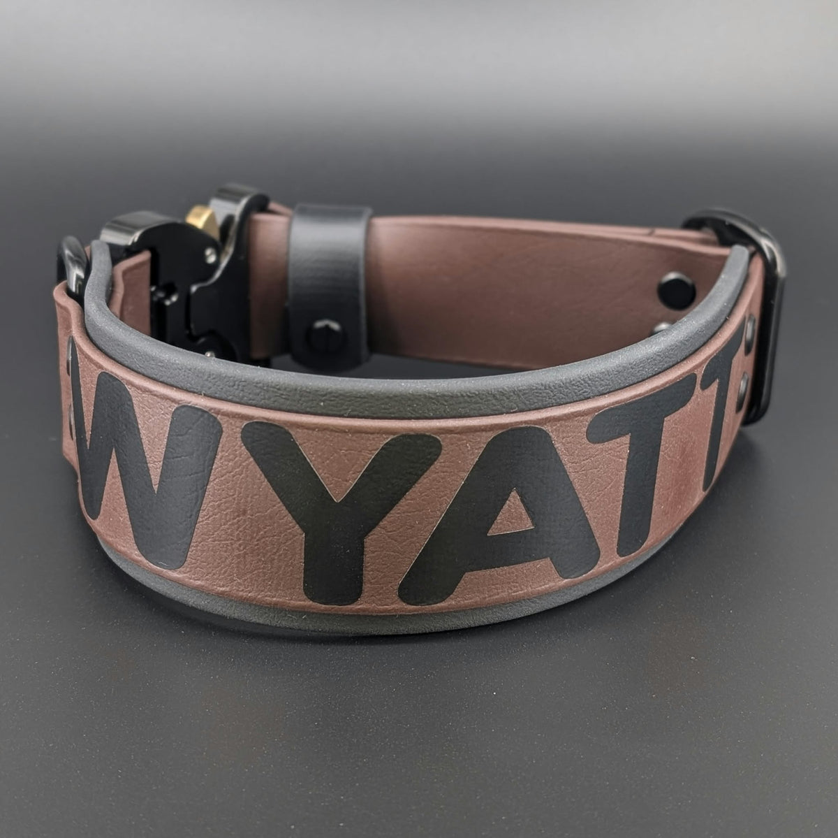 custom 2 inch wide black and dark brown layered biothane dog collar with black quick release cobra buckle and personalized text