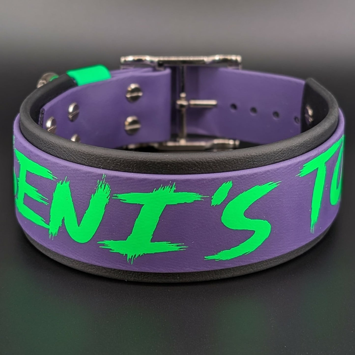 custom 2 inch wide black and dark purple layered biothane dog collar with light green scratch text