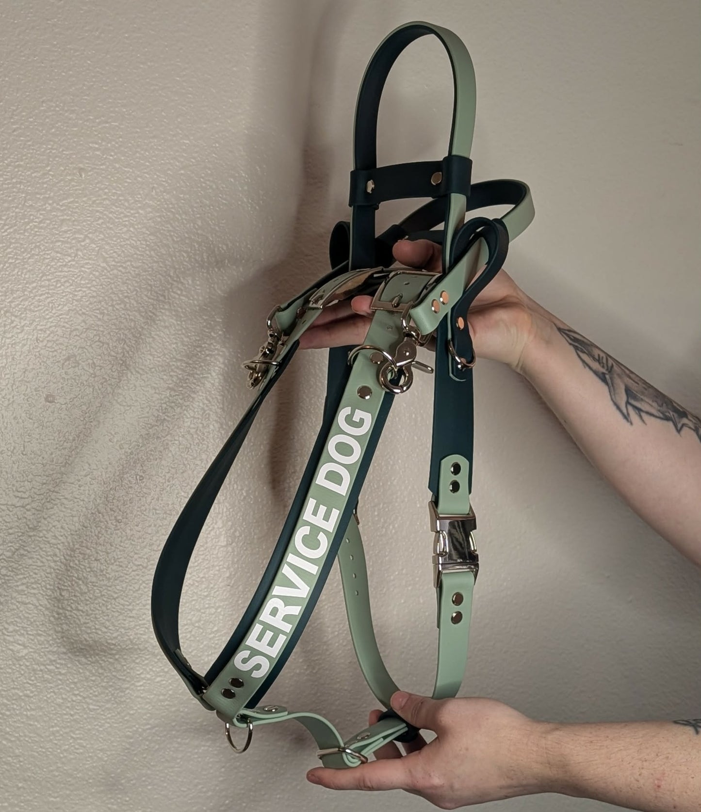dark and sage green layered biothane mobility harness with counterbalance handle and pull strap and service dog text across the shoulder straps