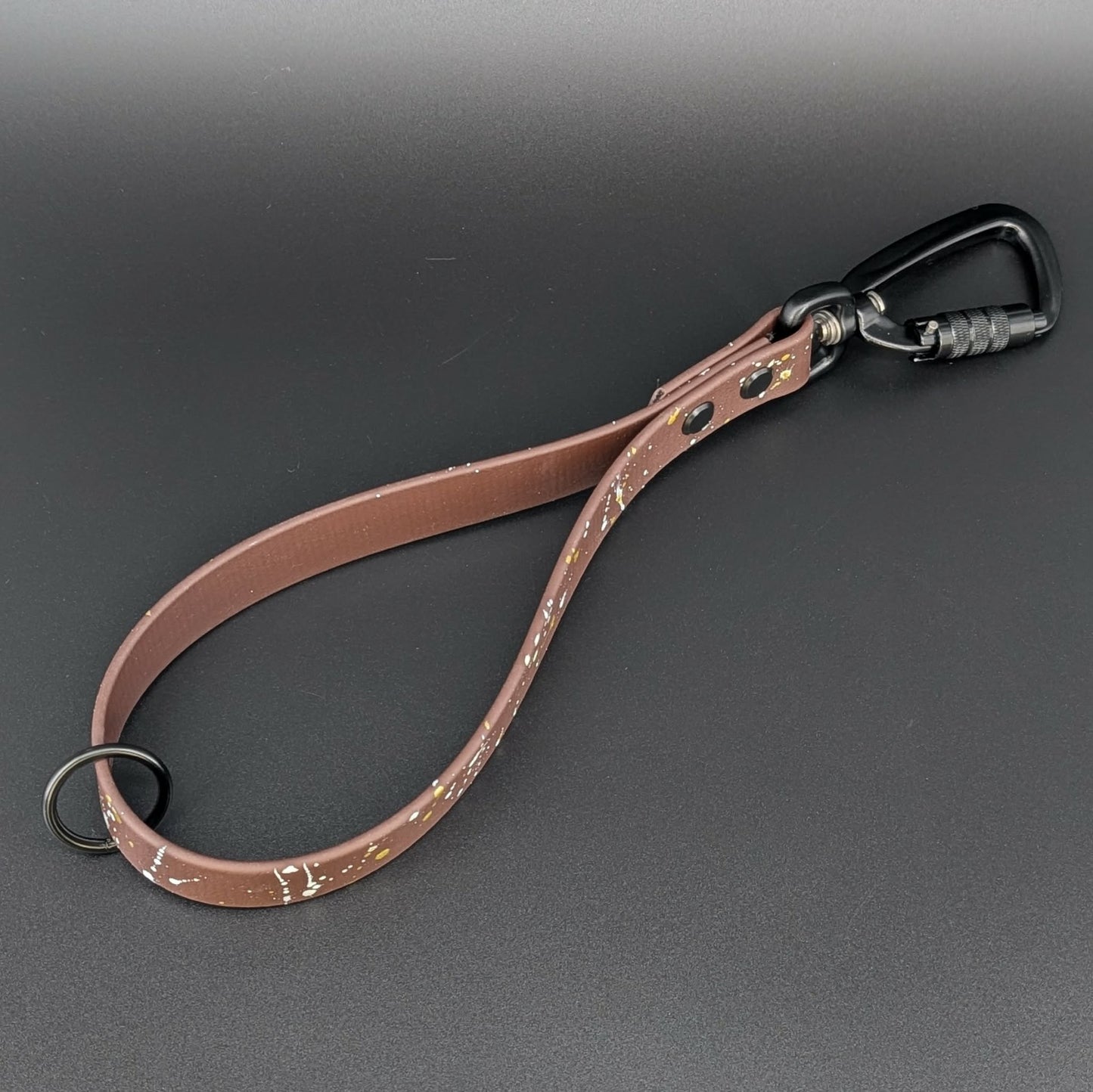 dark brown biothane traffic lead with gold and white splatter paint with black carabiner clip