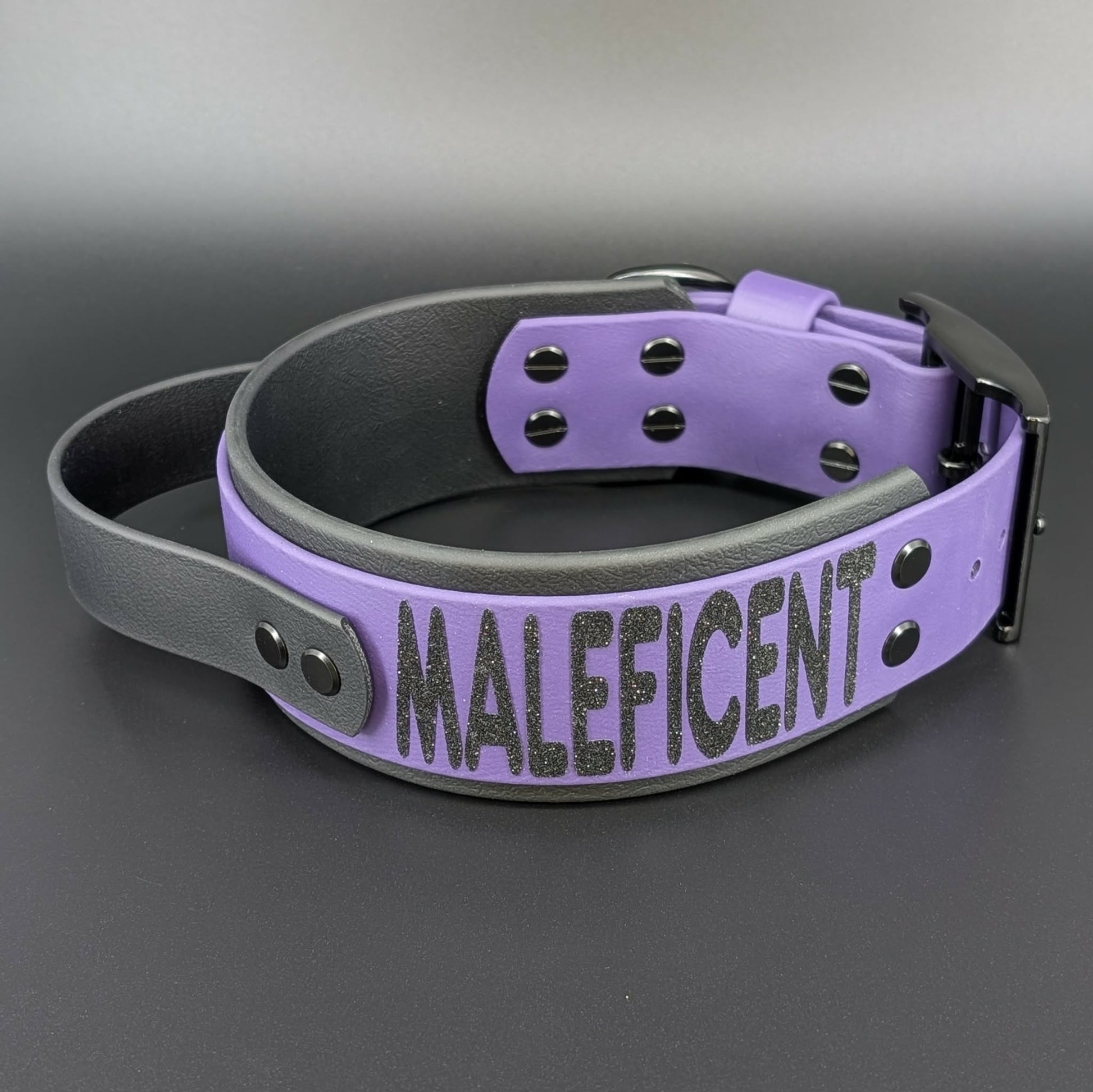 dark purple and black layered biothane dog collar with tactical handle and custom glitter text