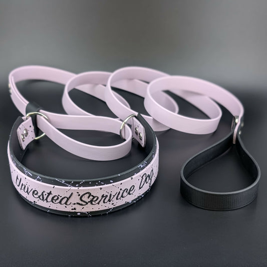 lavender and black layered biothane French martingale with splatter paint and custom text reading : Unvested Service Dog