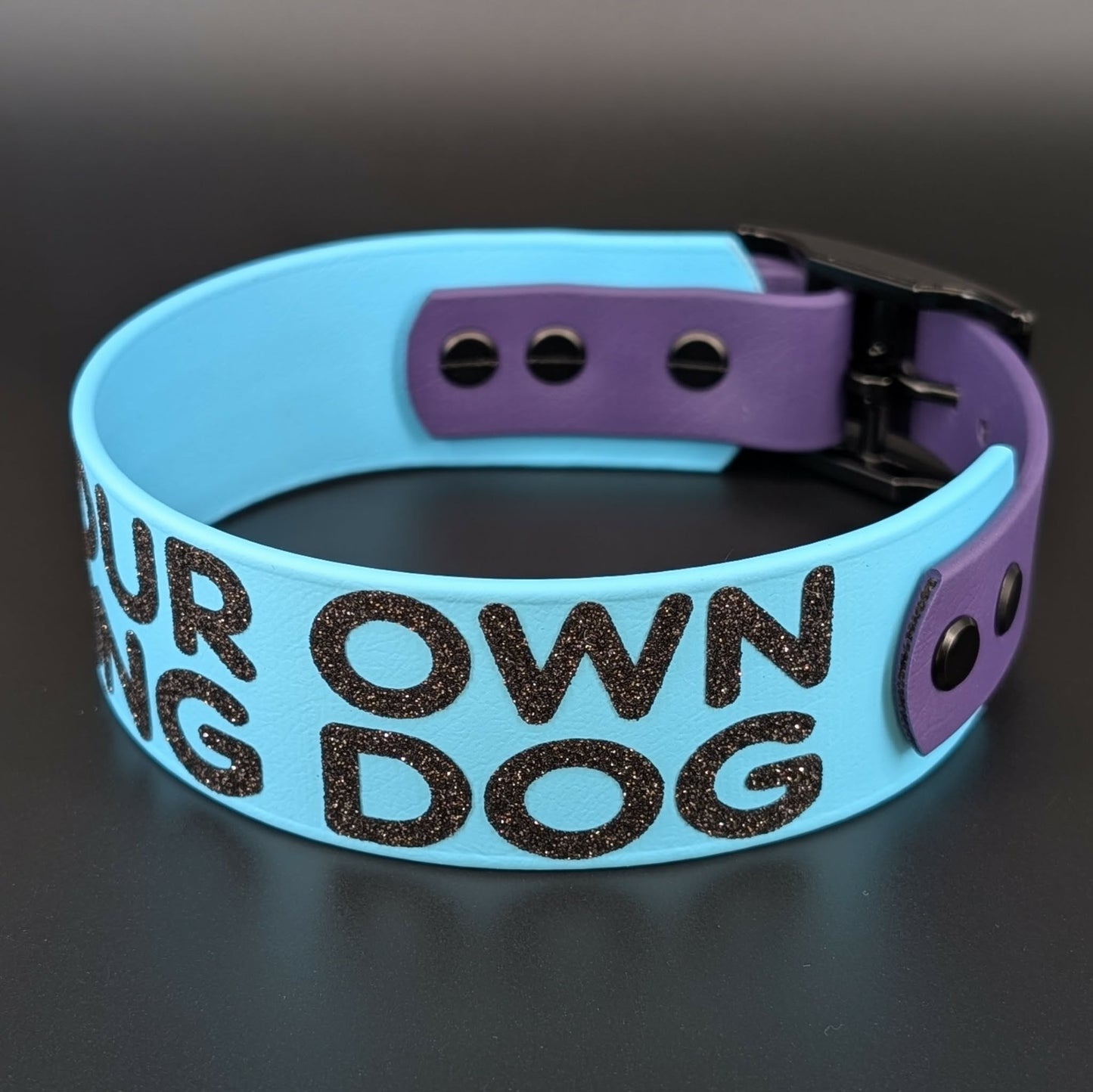 light blue and dark purple tapered biothane dog collar with glitter text