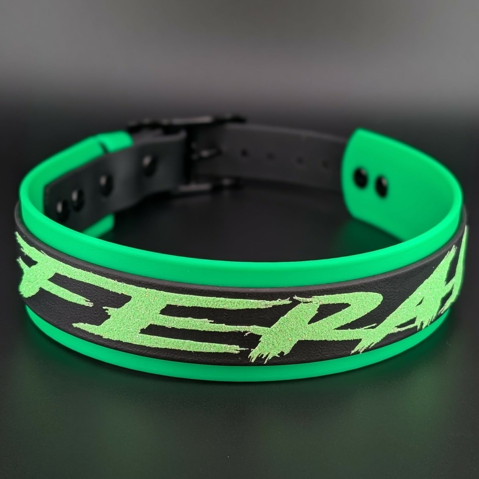 light green and black layered biothane dog collar with feral text