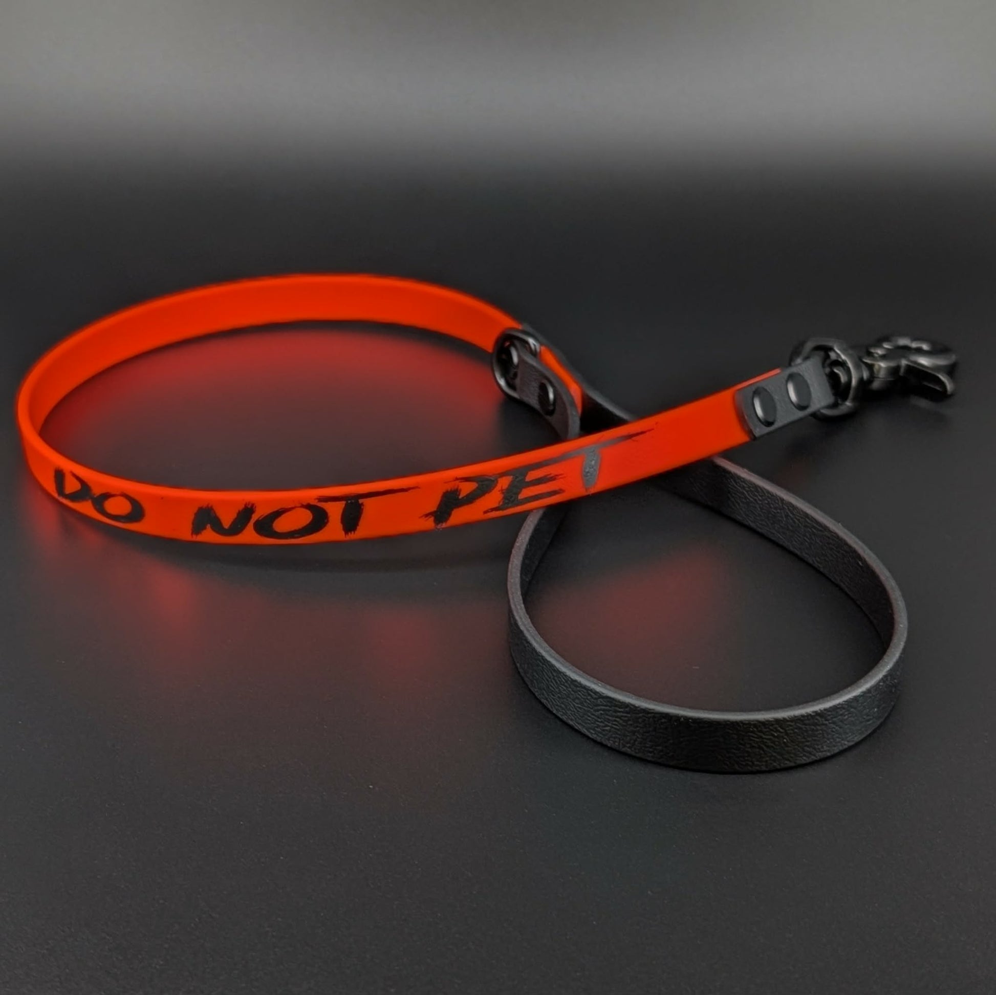 orange and black biothane dog leash with do not-pet text