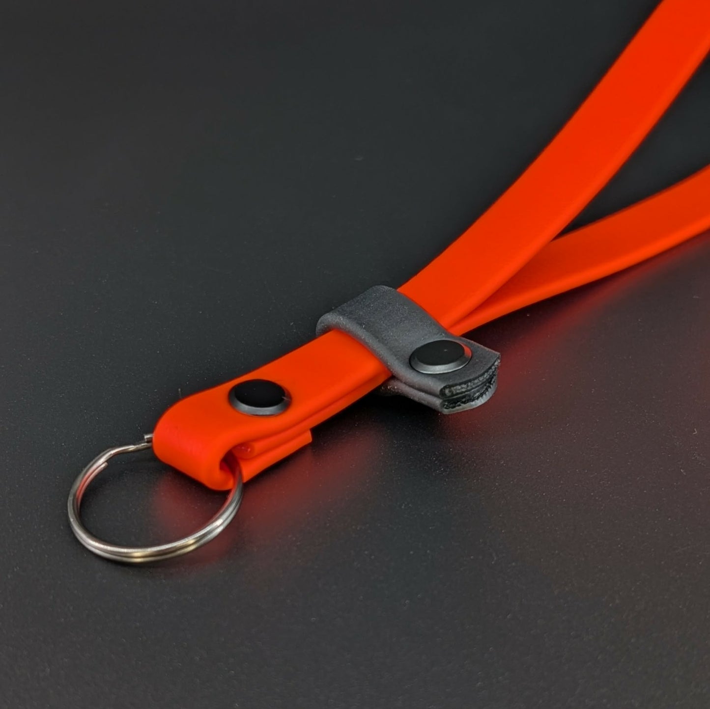 orange and black biothane wrist strap for e-collar transmitter
