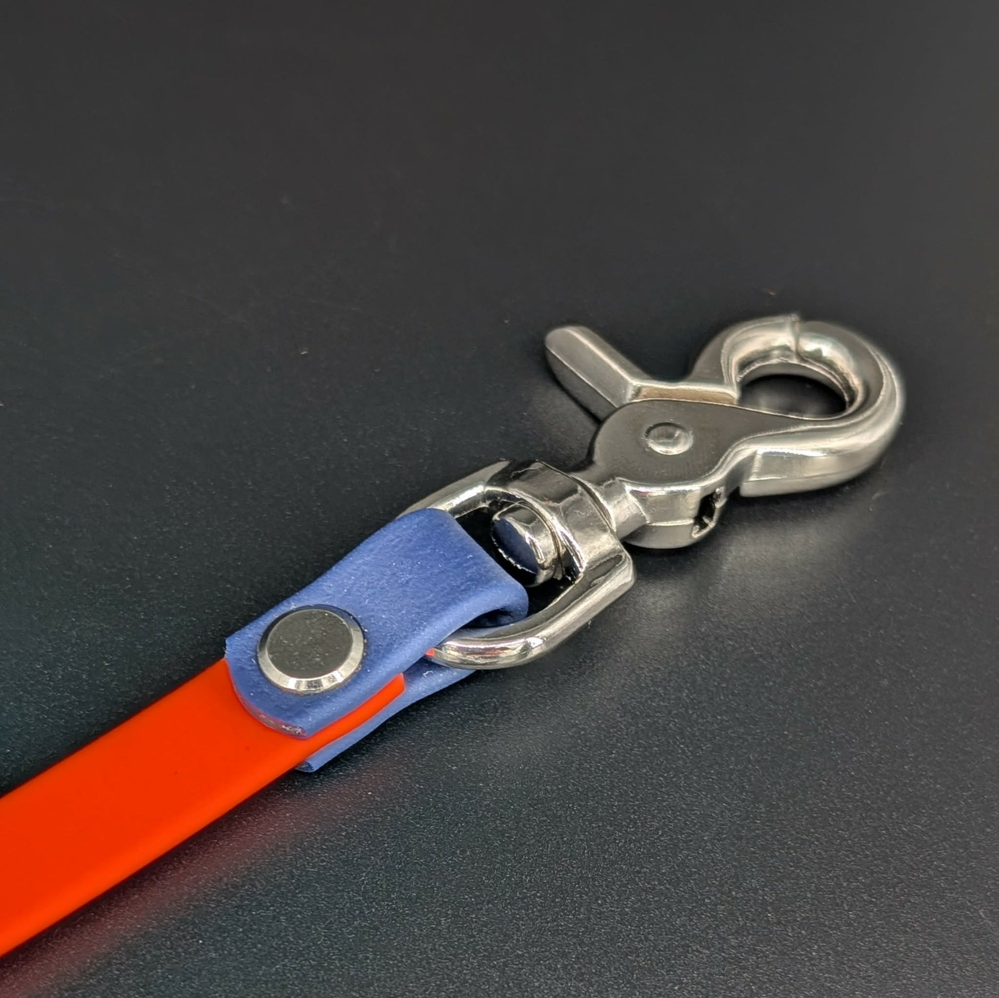 orange and navy blue biothane prong collar backup clip with silver hardware