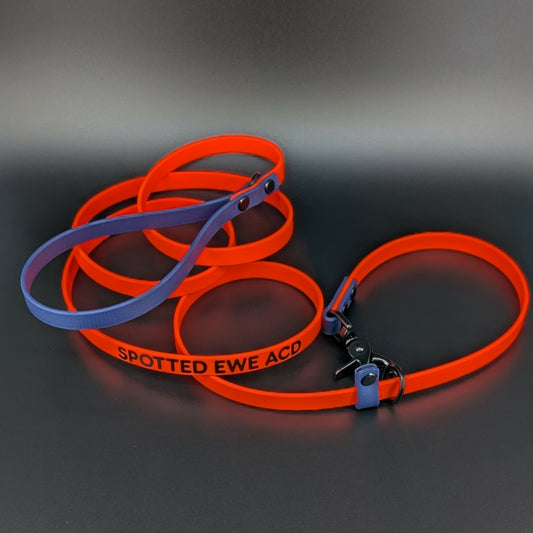 orange and navy blue biothane slip lead with convertible quick release clip and custom text