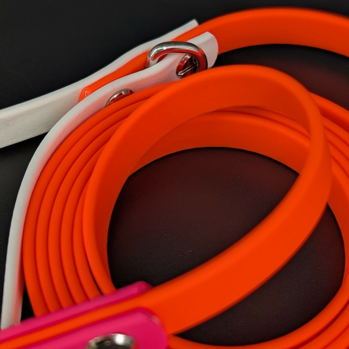 orange biothane dog leash with white and pink accents