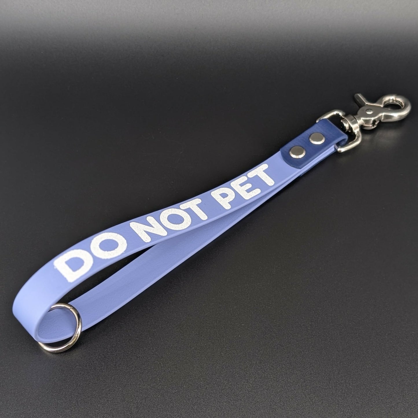 periwinkle and navy blue biothane traffic handle with DO NOT PET text in white glitter
