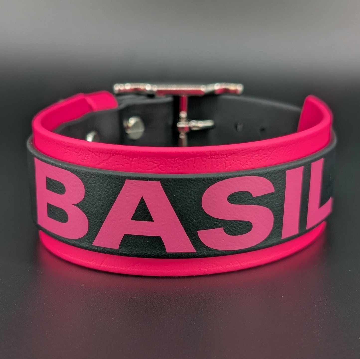 pink and black layered biothane dog collar with custom text reading basil