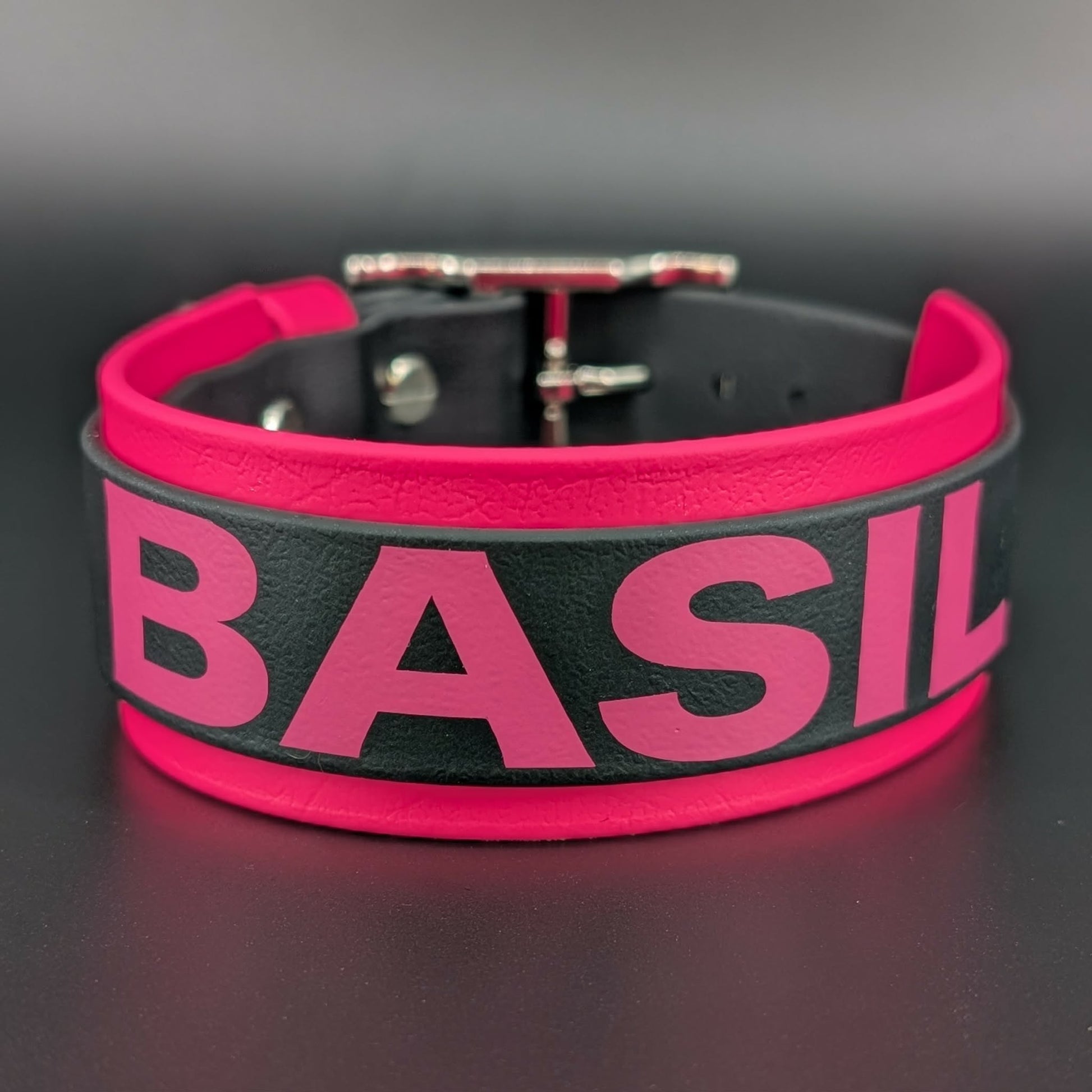 pink and black layered biothane dog collar with custom text reading basil