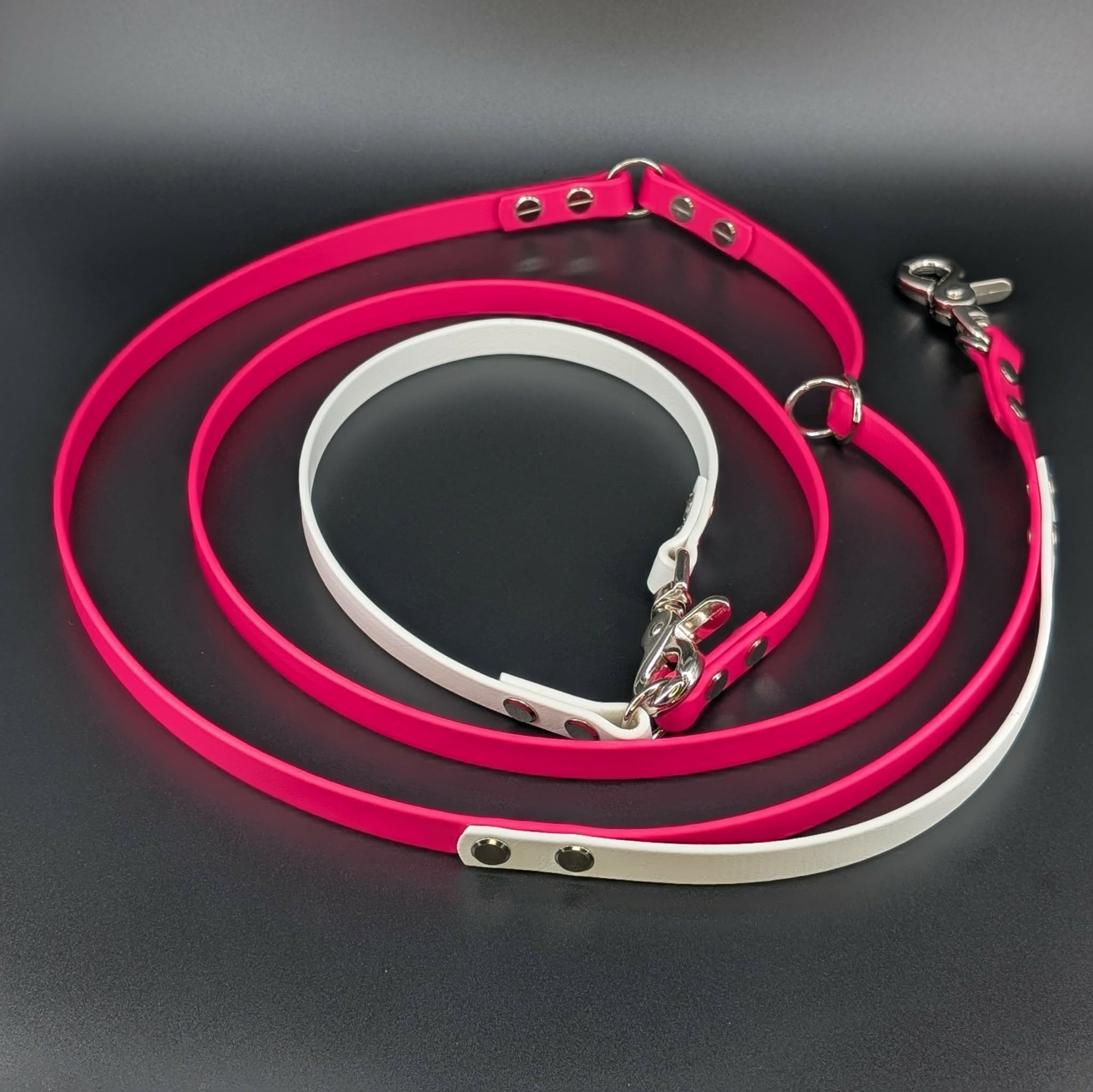 pink and white biothane hands free dog leash with adjustable waist attachment and traffic handle